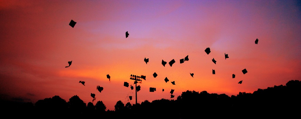 graduation caps in the air