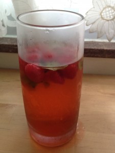 A tall glass of strawberry basil Infused water