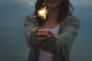 woman holding sparkler firework