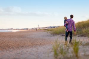 father and kid on the beach