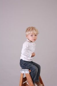 boy sitting on ladder