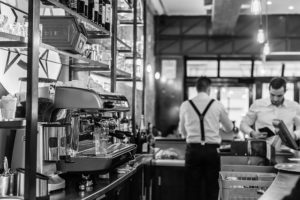 A man standing behind the counter at a restaurant