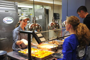 Student workers serve students their meals