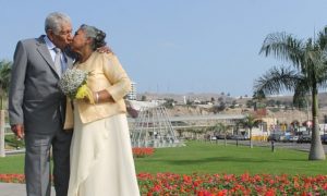 elderly couple in nice clothes kissing