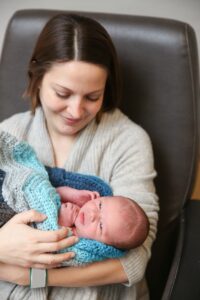 a woman holding a newborn baby