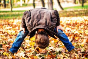 child in leaves