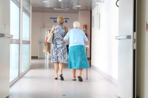 A mother and daughter walking in the hallway of the hospital