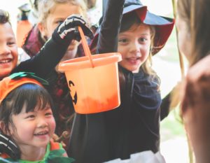 Kids dressed in Halloween costumes trick-or-treating