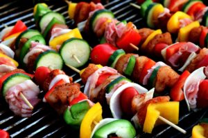 Meat and vegetable shish kebabs on grill.