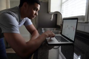 Person using laptop to look up financial information