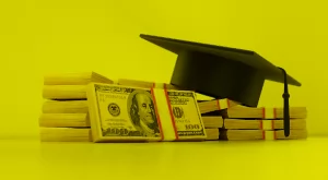 Graduation cap on a stack of money