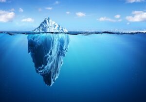 An Iceberg in blue water, mostly underwater