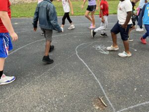 Kids with chalk drawn labyrinth