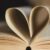 pages of open book shaped into a heart